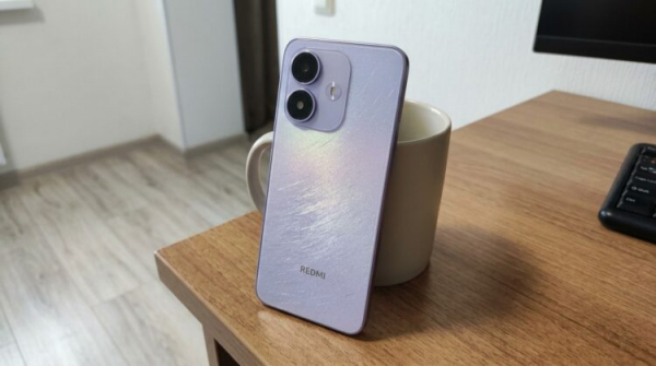 Смартфон Redmi в сиреневом корпусе на столе
